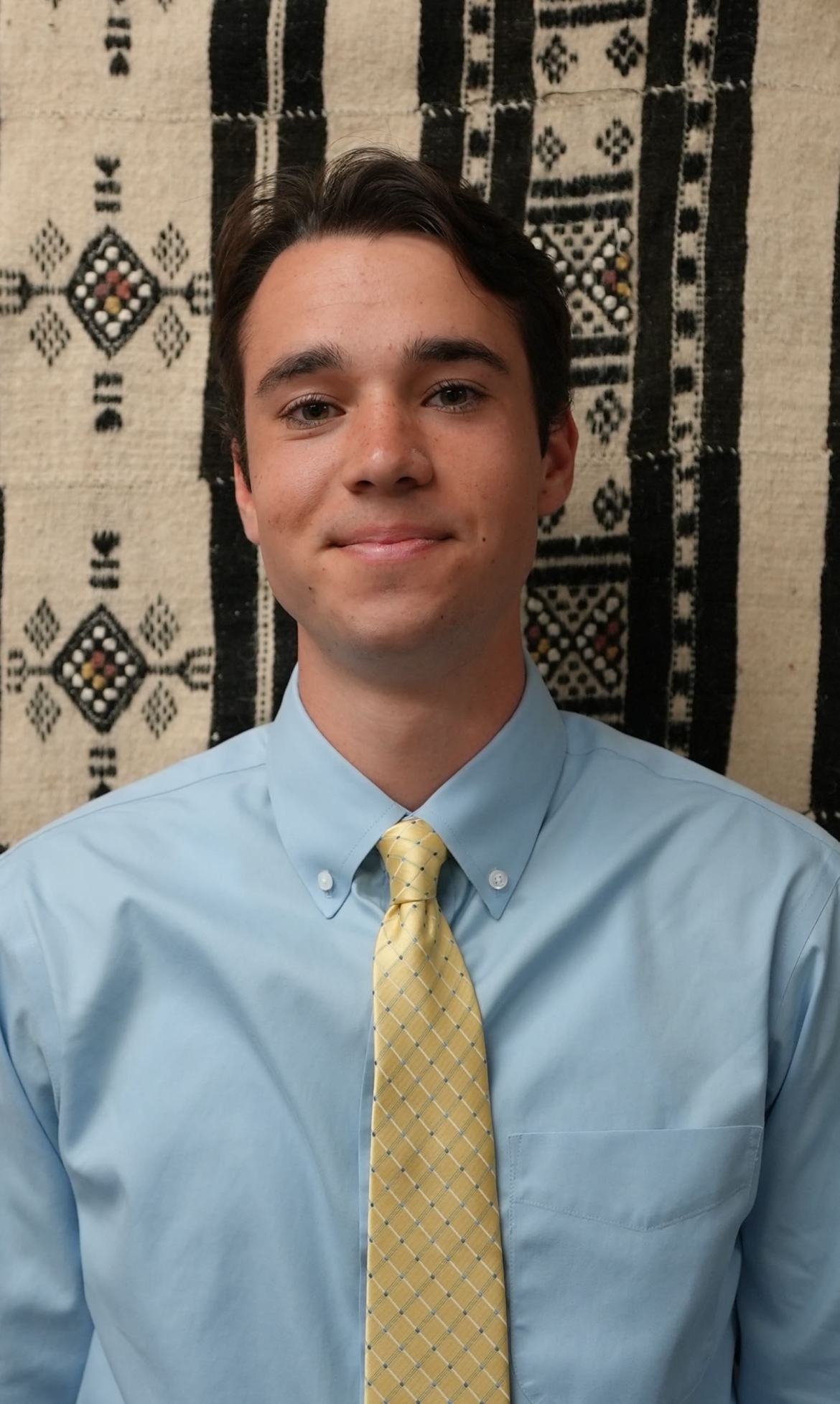 Charlie Martino, a 21-year-old white male smiles for the photo. He has brown hair and green eyes.